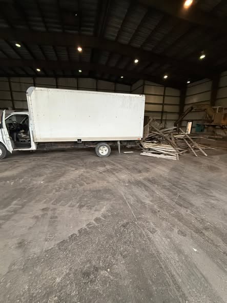 785 Junk Removal truck unloading debris at the disposal facility